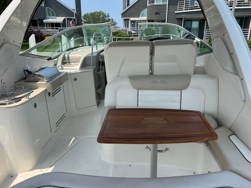 Slide: The Image of 2011 Sea Ray 330 Sundancer interior with seating and wooden table. - 5