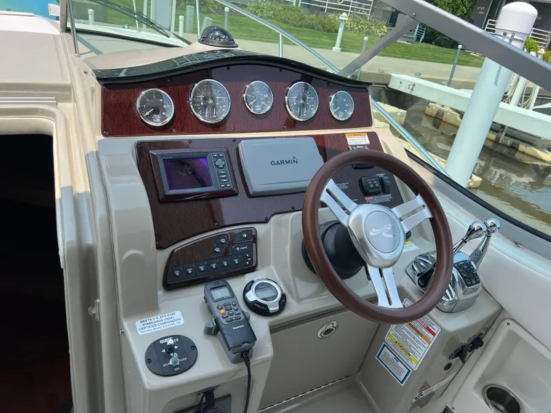 Slide: The Image of Cockpit of 2011 Sea Ray 330 Sundancer with Garmin navigation and wood-accented dashboard. - 9