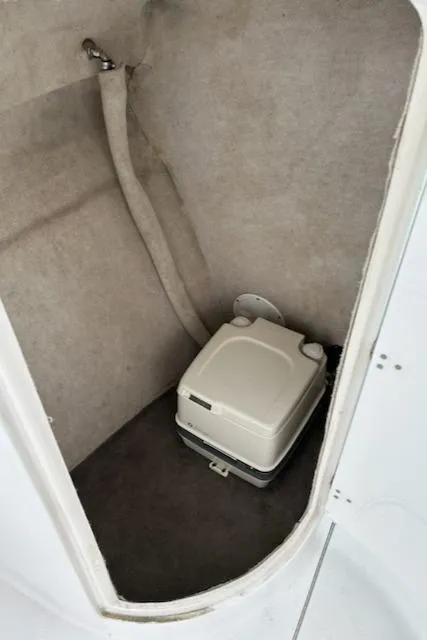 Slide: The Image of Portable toilet in 2005 Seaswirl Striper 2301 Dual Console O/B boat compartment. - 14