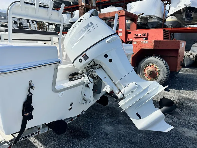 Slide: The Image of 2022 Clearwater 2000CC boat with Suzuki outboard motor in a storage yard. - 13