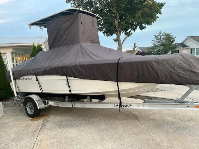 Slide: The Image of Covered 2022 Clearwater 2000CC boat on trailer, parked in driveway. - 15