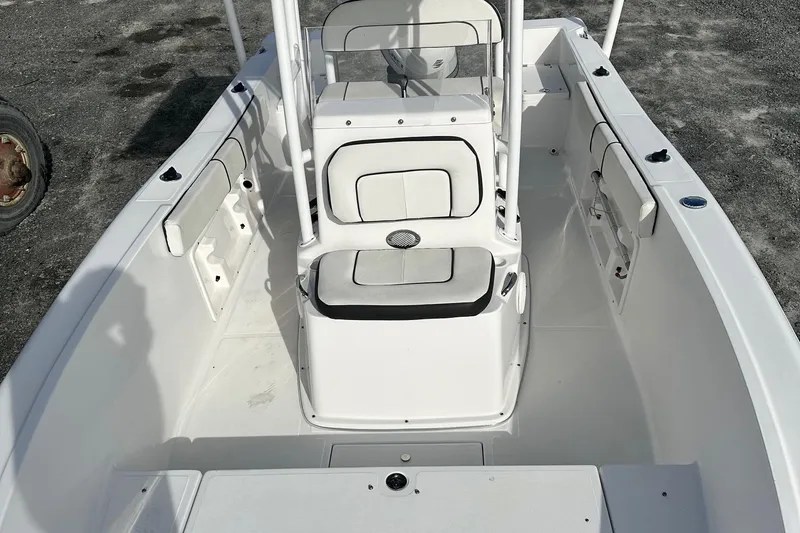 Slide: The Image of 2022 Clearwater 2000CC boat interior with white seating and console. - 6