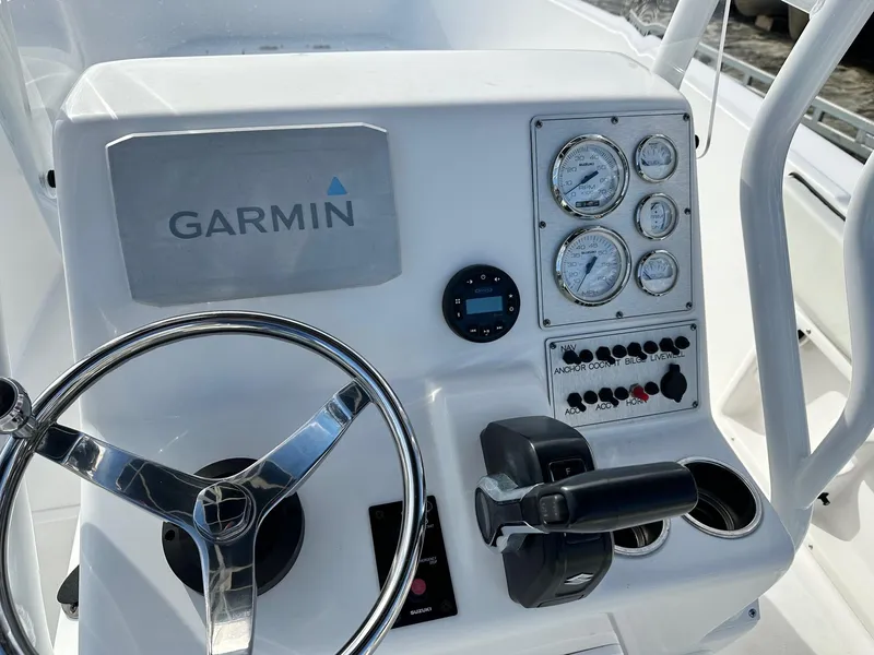 Slide: The Image of Clearwater 2000CC 2022 boat dashboard with Garmin navigation and control panel. - 8