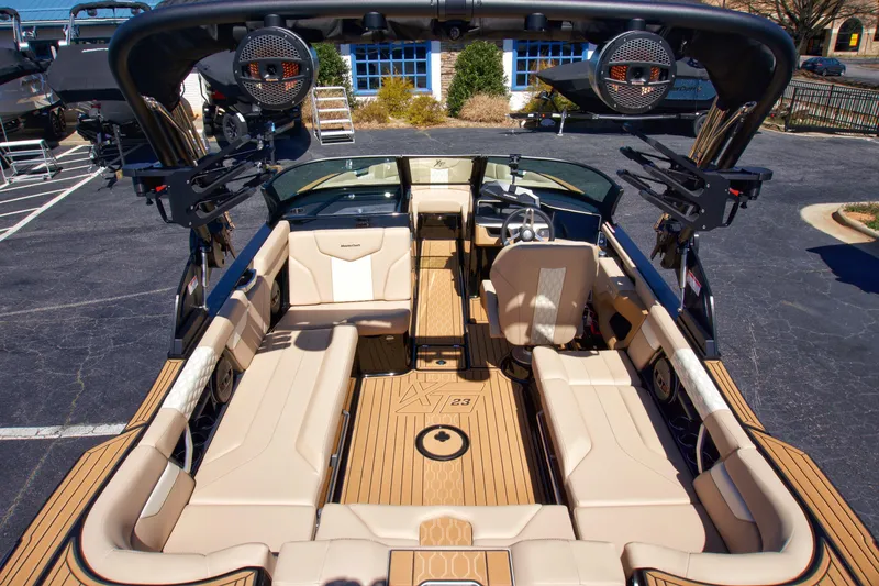 Slide: The Image of 2025 MasterCraft XT23 boat interior with luxurious seating and advanced audio system. - 8