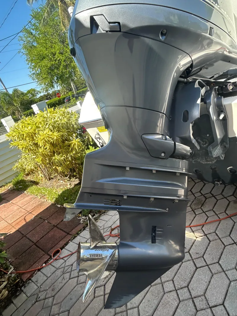 Slide: The Image of 2023 Release 210 RX boat motor with propeller, outdoor setting, sunny day. - 11