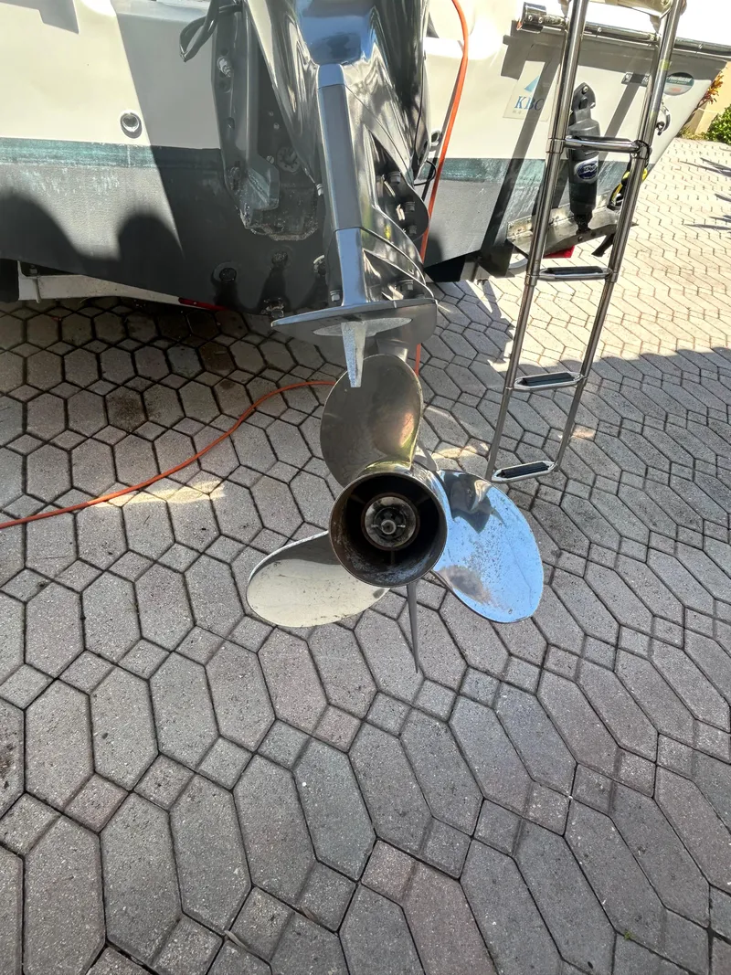 Slide: The Image of Outboard motor of 2023 Release 210 RX boat on hexagonal pavement. - 12