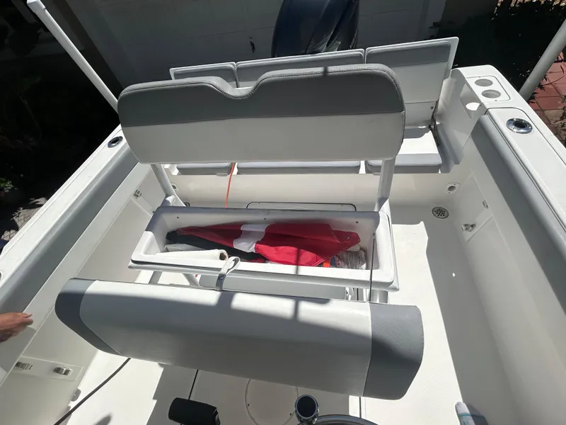 Slide: The Image of 2023 Release 210 RX boat interior with open storage compartment and seating. - 20