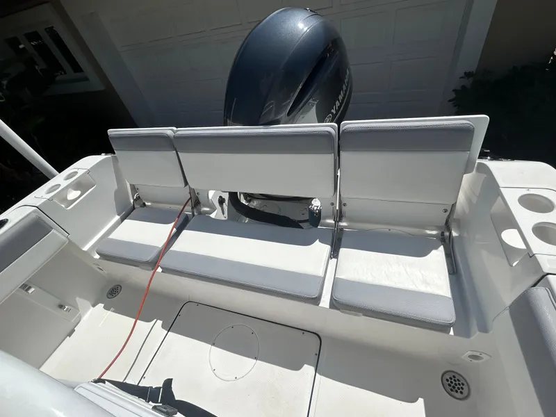 Slide: The Image of 2023 Release 210 RX boat interior with seating and outboard motor. - 21