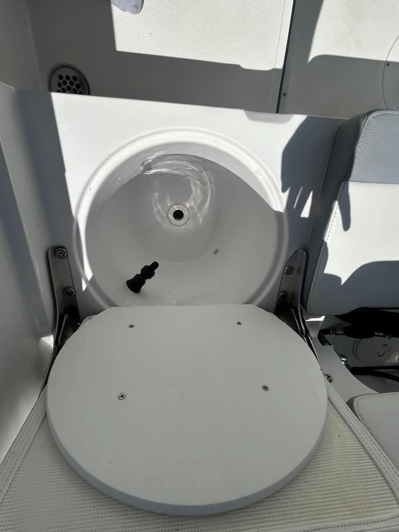 Slide: The Image of 2023 Release 210 RX boat seat with storage compartment, white interior. - 22