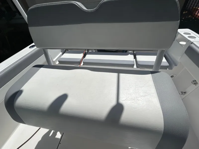 Slide: The Image of 2023 Release 210 RX boat seat with gray and white upholstery. - 23