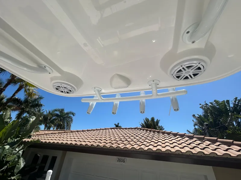 Slide: The Image of Rooftop view of 2023 Release 210 RX boat with speakers and rod holders. - 29