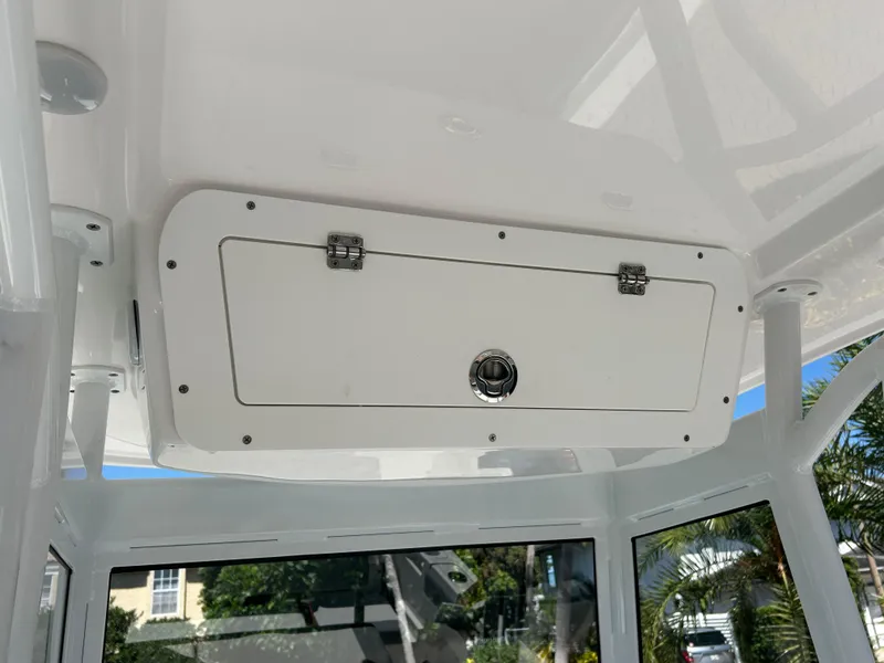 Slide: The Image of 2023 Release 210 RX boat storage compartment with secure latch, white finish. - 30