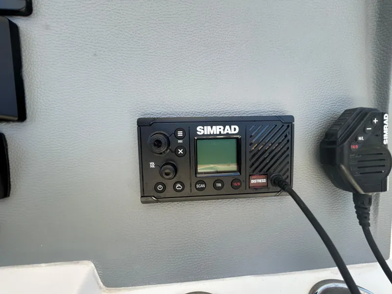 Slide: The Image of Simrad marine radio on 2023 Release 210 RX boat dashboard. - 32
