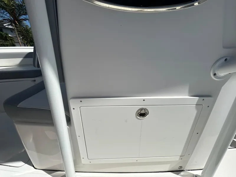 Slide: The Image of 2023 Release 210 RX boat console with storage compartment and seating. - 33