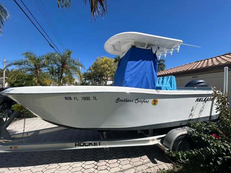 Slide: The Image of 2023 Release 210 RX boat on trailer, labeled "Southern Comfort," under clear blue sky. - 37
