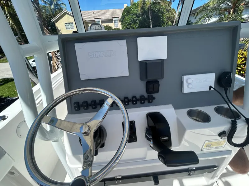 Slide: The Image of 2023 Release 210 RX boat dashboard with steering wheel and control panel. - 49