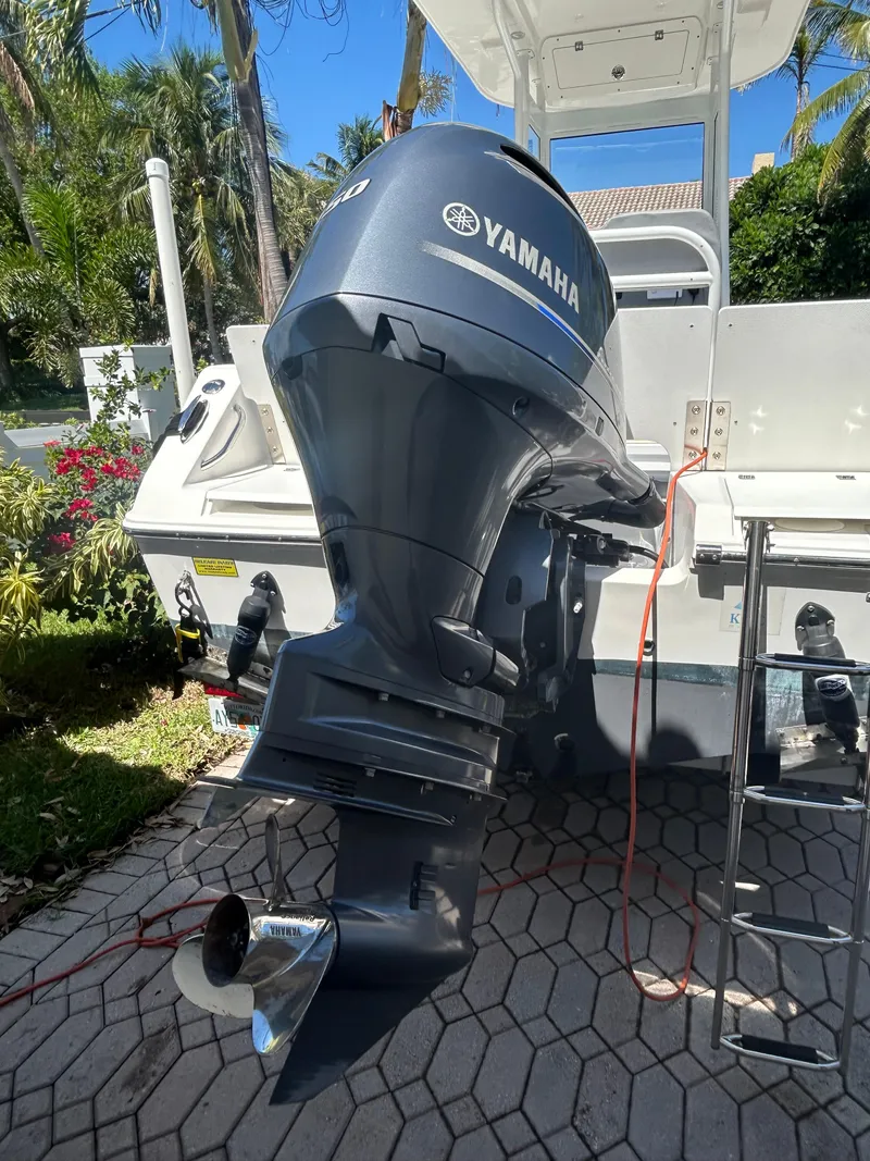 Slide: The Image of Yamaha outboard motor on 2023 Release 210 RX boat, parked on a sunny driveway. - 7