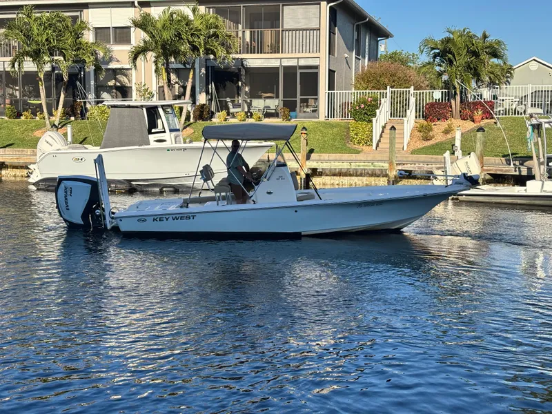 Slide: The Image of 2017 Key West 230 Bay Reef boat docked in a sunny waterfront setting. - 0