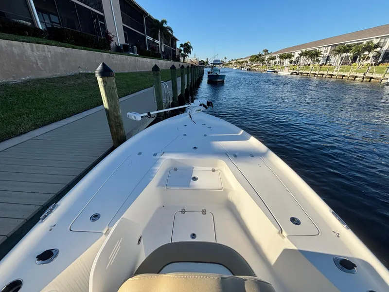 Slide: The Image of 2017 Key West 230 Bay Reef boat docked by a canal on a sunny day. - 11