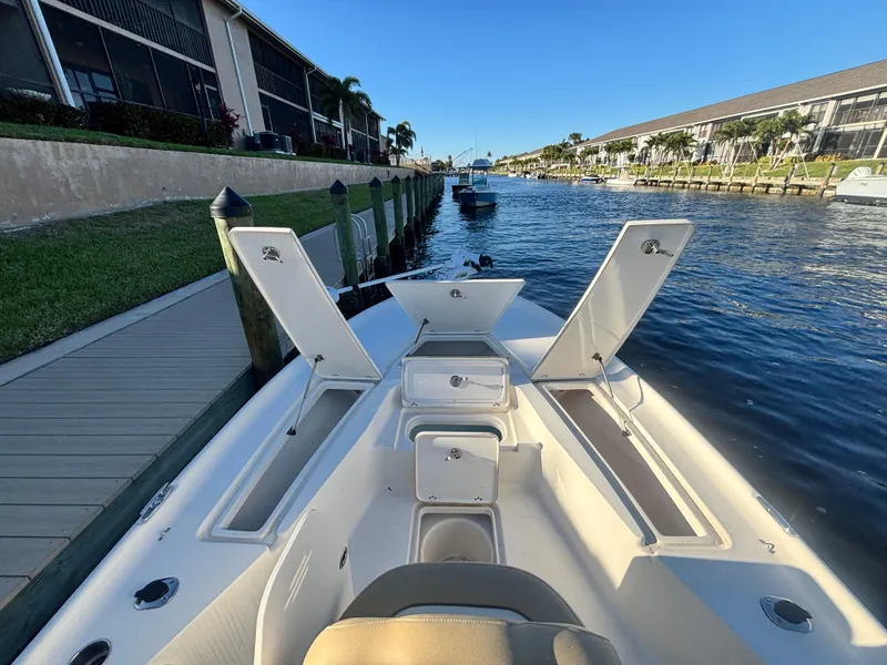 Slide: The Image of 2017 Key West 230 Bay Reef boat docked on a sunny canal. - 12