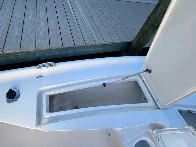 Slide: The Image of 2017 Key West 230 Bay Reef boat storage compartment open by dock. - 13
