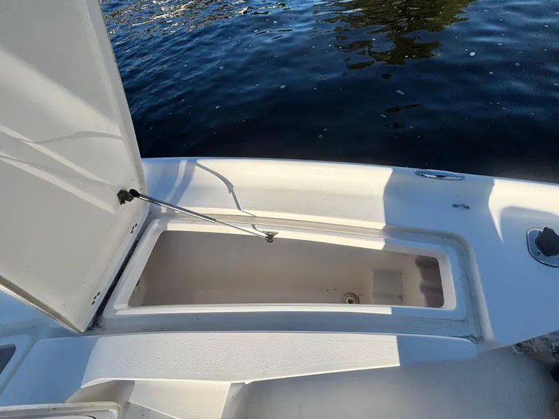 Slide: The Image of Open storage compartment on 2017 Key West 230 Bay Reef boat by the water. - 14