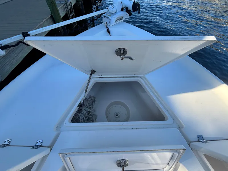 Slide: The Image of 2017 Key West 230 Bay Reef boat with open storage compartment near water. - 15