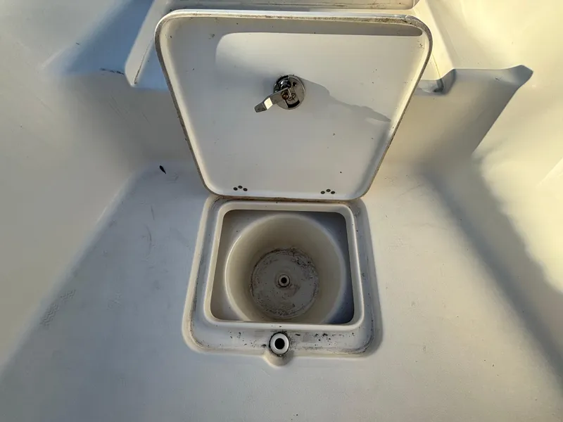 Slide: The Image of 2017 Key West 230 Bay Reef boat compartment with open hatch and drain. - 16
