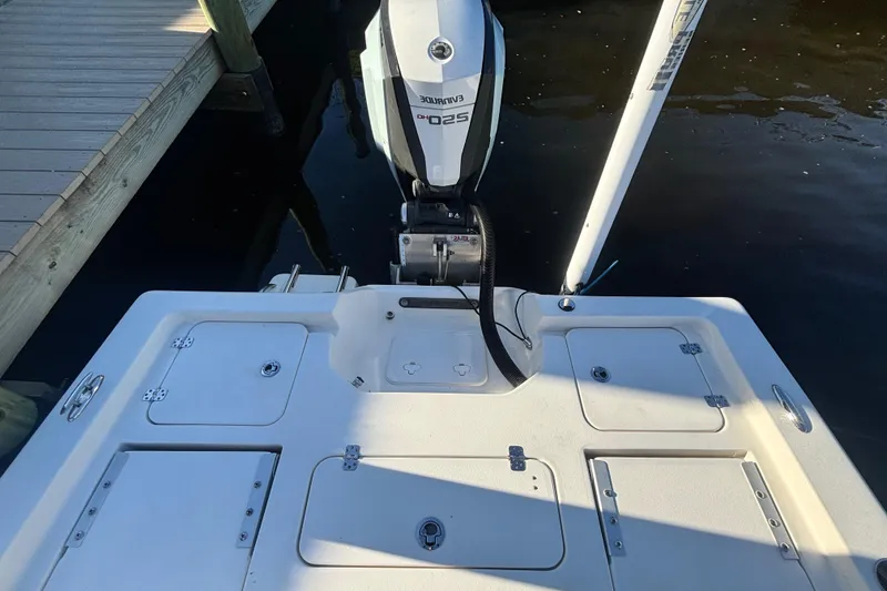 Slide: The Image of 2017 Key West 230 Bay Reef boat with outboard motor, docked by wooden pier. - 18