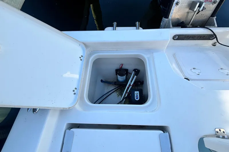 Slide: The Image of Open storage compartment on 2017 Key West 230 Bay Reef boat, showing equipment inside. - 21