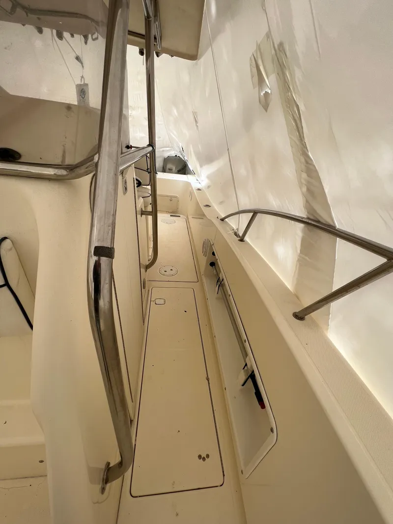 Slide: The Image of 1998 World Cat 270TE boat interior with railings and storage compartments. - 13
