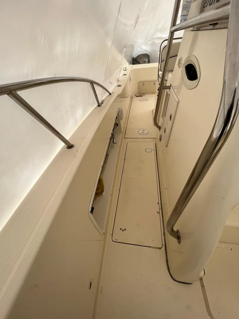 Slide: The Image of 1998 World Cat 270TE boat deck with stainless steel railings and storage compartments. - 14