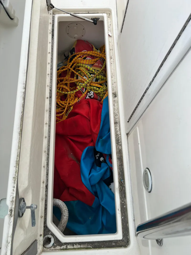 Slide: The Image of Storage compartment on a 1998 World Cat 270TE boat with ropes and fabric. - 16