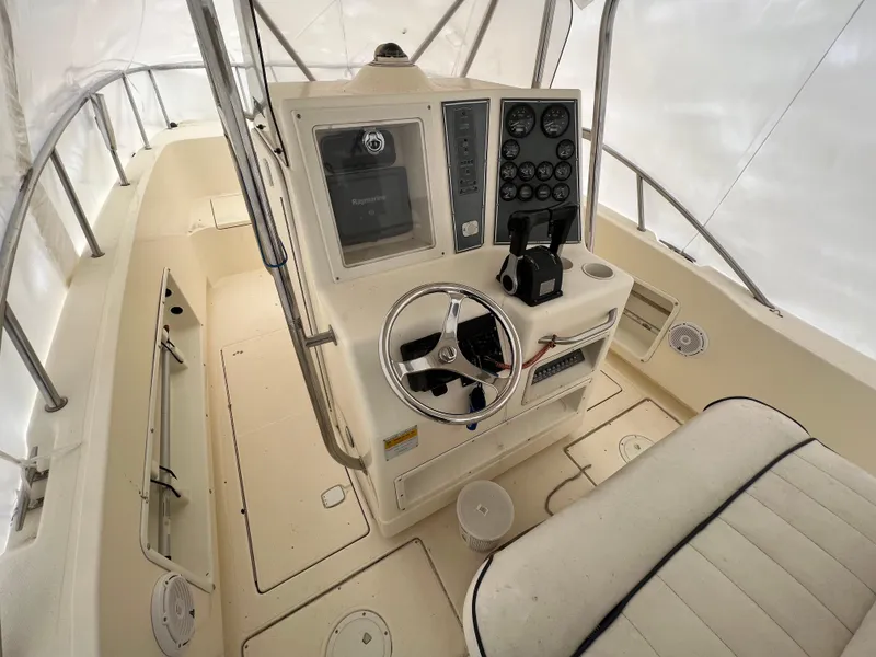 Slide: The Image of 1998 World Cat 270TE boat cockpit with steering wheel and control panel. - 19