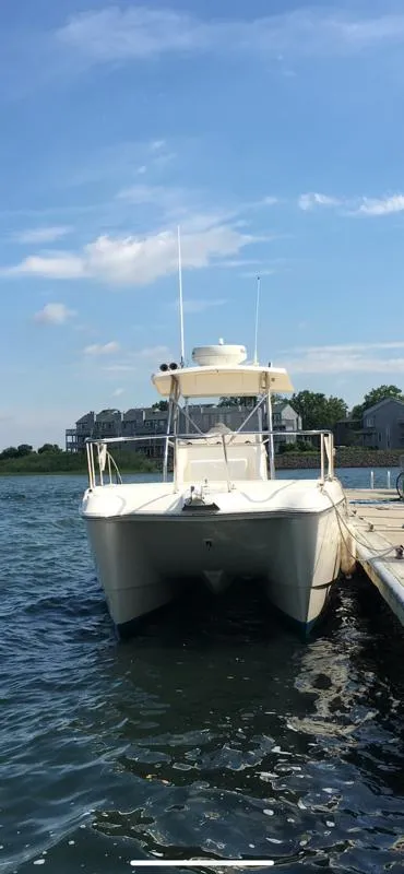 Slide: The Image of 1998 World Cat 270TE boat docked on a sunny day with blue sky. - 2