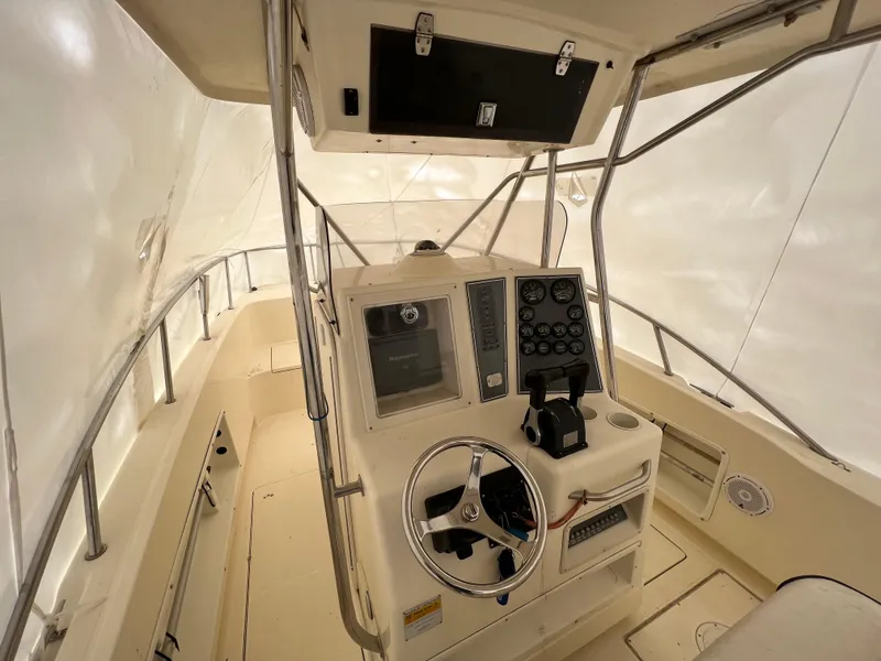 Slide: The Image of 1998 World Cat 270TE boat interior with steering wheel and control panel. - 20