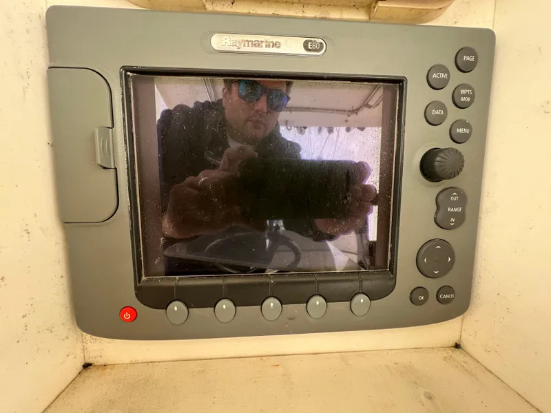 Slide: The Image of Raymarine E80 display on 1998 World Cat 270TE boat, showing reflection of a person. - 21