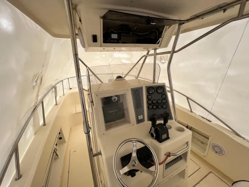 Slide: The Image of 1998 World Cat 270TE boat interior with steering wheel and control panel. - 22