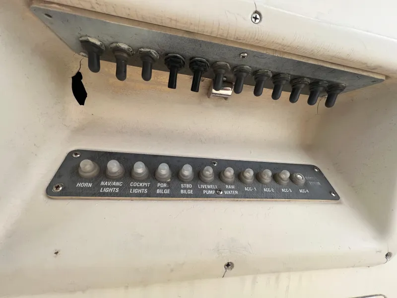 Slide: The Image of Control panel of a 1998 World Cat 270TE boat with labeled switches. - 25