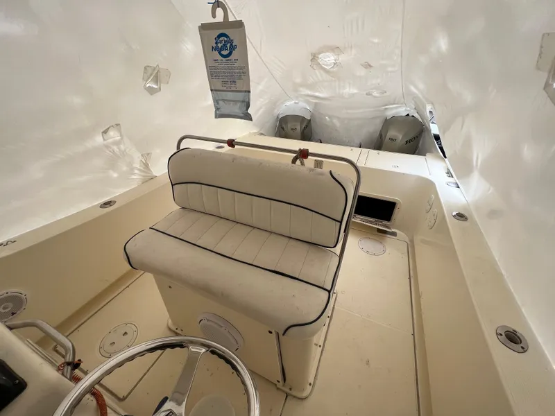 Slide: The Image of 1998 World Cat 270TE boat interior with seating and dual engines. - 26