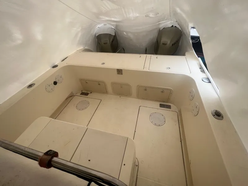 Slide: The Image of 1998 World Cat 270TE boat interior with dual engines, spacious deck, and storage compartments. - 27