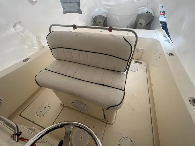 Slide: The Image of 1998 World Cat 270TE boat interior with cushioned seating and dual outboard motors. - 28