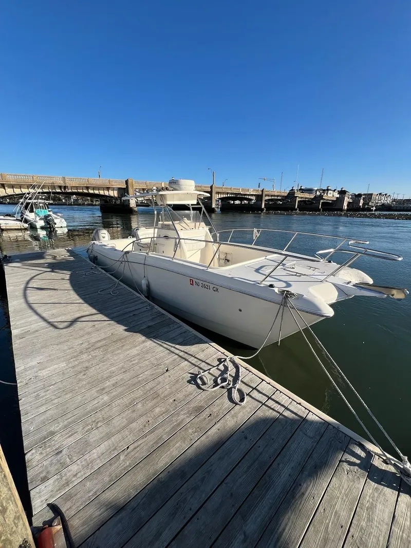 Slide: The Image of 1998 World Cat 270TE boat docked at a marina under clear blue skies. - 3