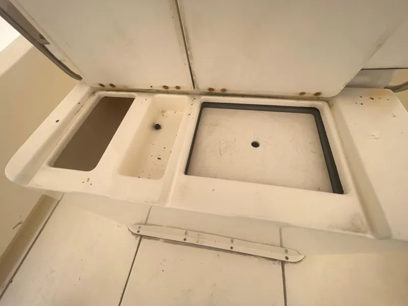Slide: The Image of 1998 World Cat 270TE boat storage compartments, open and empty, showing interior layout. - 30