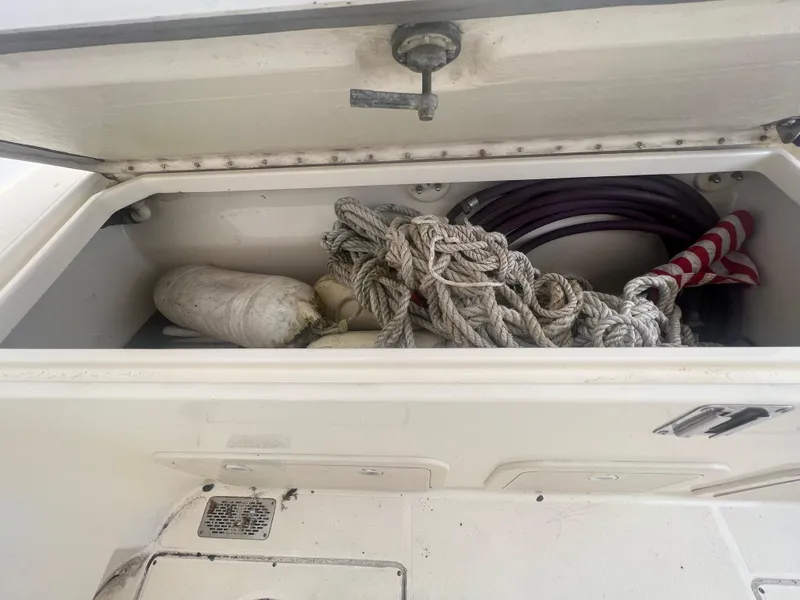 Slide: The Image of Storage compartment on a 1998 World Cat 270TE boat with ropes and equipment. - 32