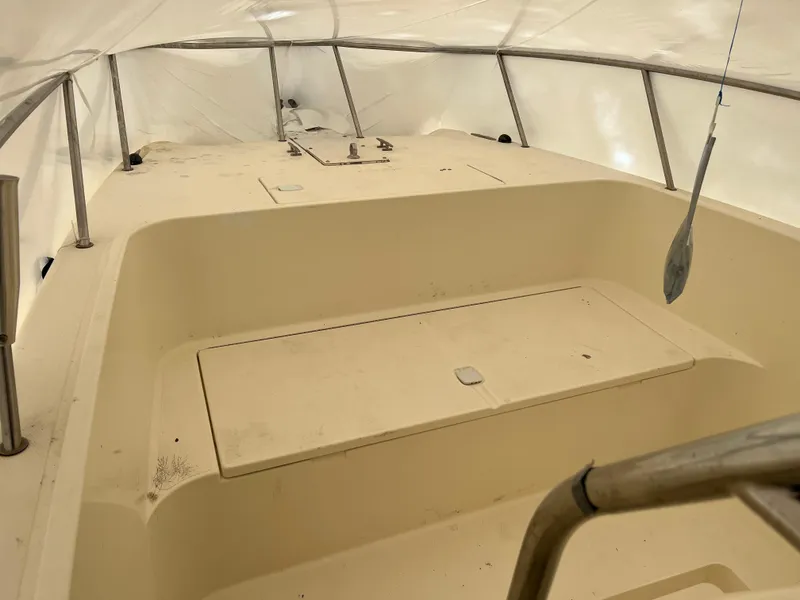 Slide: The Image of 1998 World Cat 270TE boat interior under protective cover, showing spacious deck area. - 7