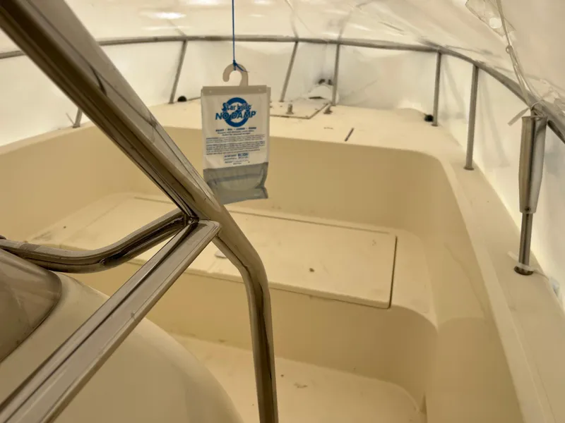 Slide: The Image of 1998 World Cat 270TE boat interior with protective cover and metal railings. - 8