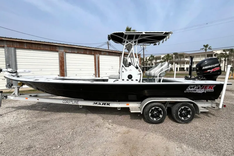 Slide: The Image of 2018 Majek 25 Extreme boat on trailer, side view, with Mercury engine. - 0