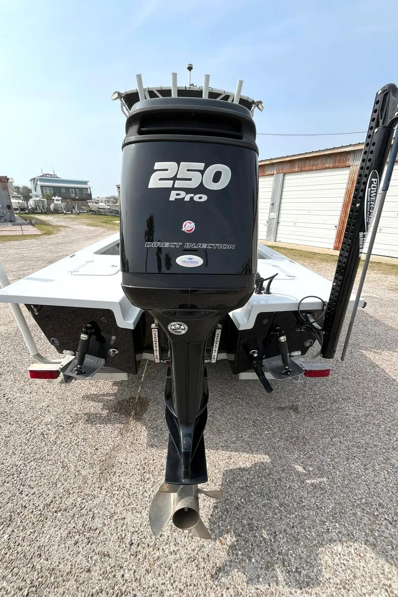 Slide: The Image of 2018 Majek 25 Extreme boat with 250 Pro outboard motor, parked outdoors. - 15