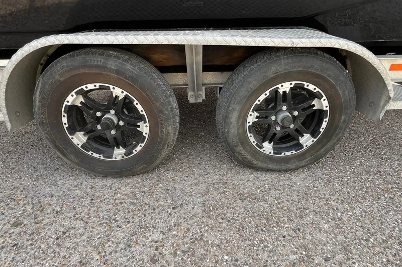 Slide: The Image of Trailer wheels of a 2018 Majek 25 Extreme boat on gravel surface. - 16